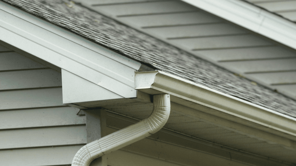 lateral view of a house with shingle roof and gutter